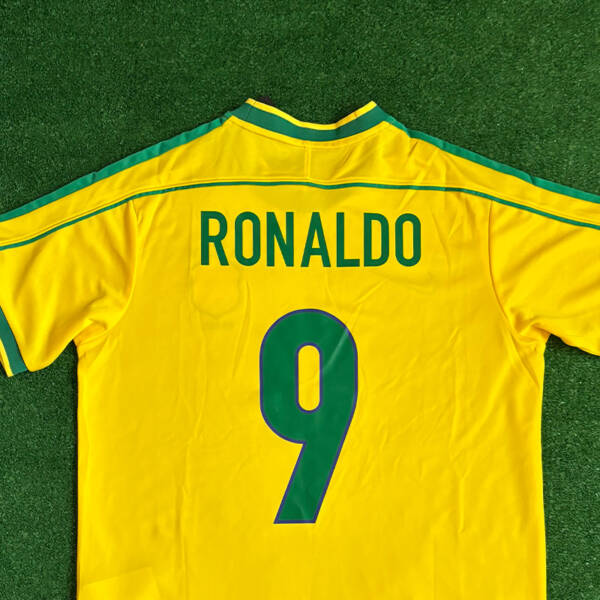 Maillot domicile Brésil 1998, jaune avec détails verts, porté par Ronaldo lors de la Coupe du Monde.